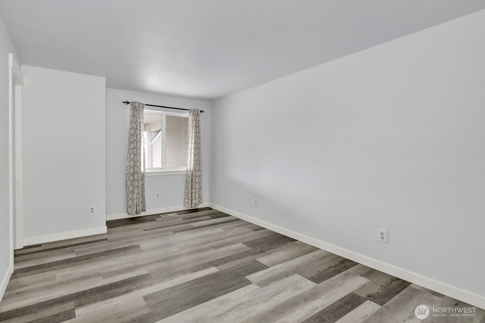 1502 Burrows Court Anacortes, WA 98221 - Photo 11 of 15 a view of an empty room with wooden floor and a window