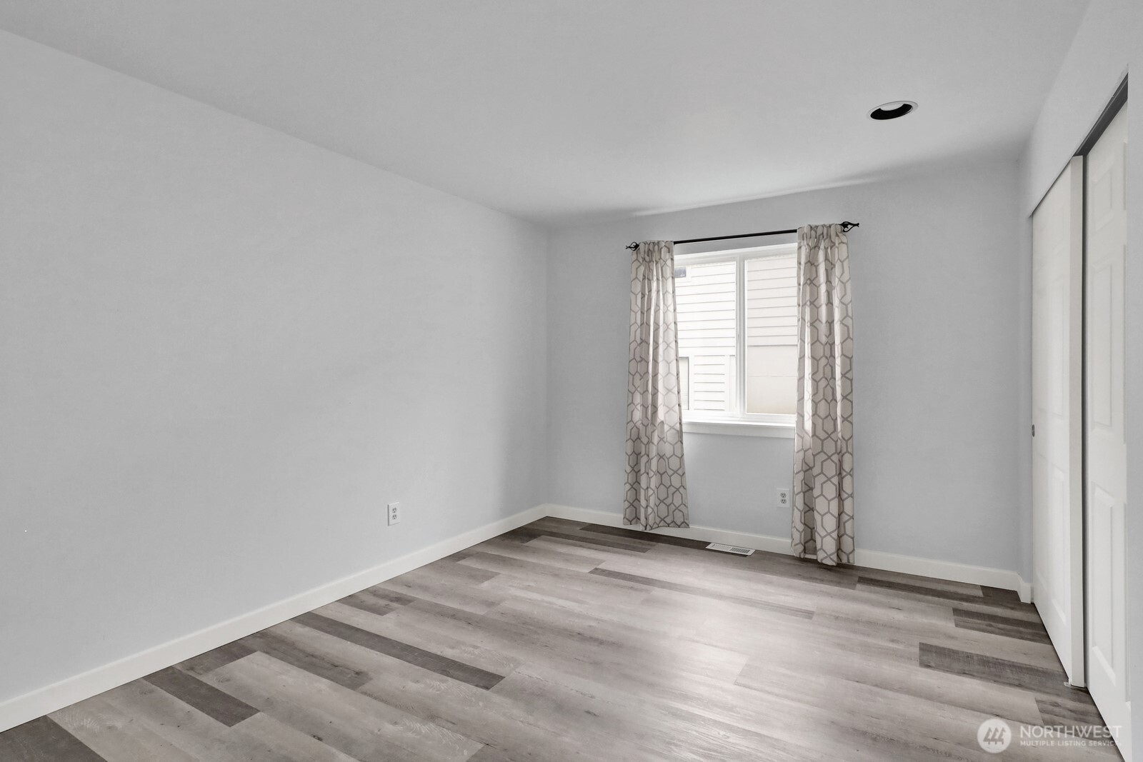 1502 Burrows Court Anacortes, WA 98221 - Photo 14 of 15 an empty room with wooden floor and windows