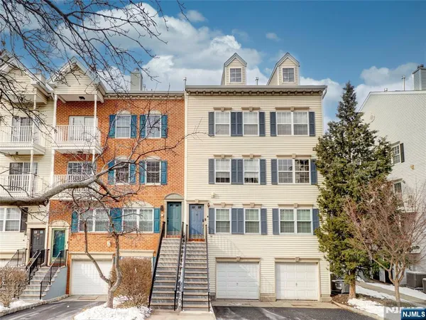 a view of a large white building next to a road
