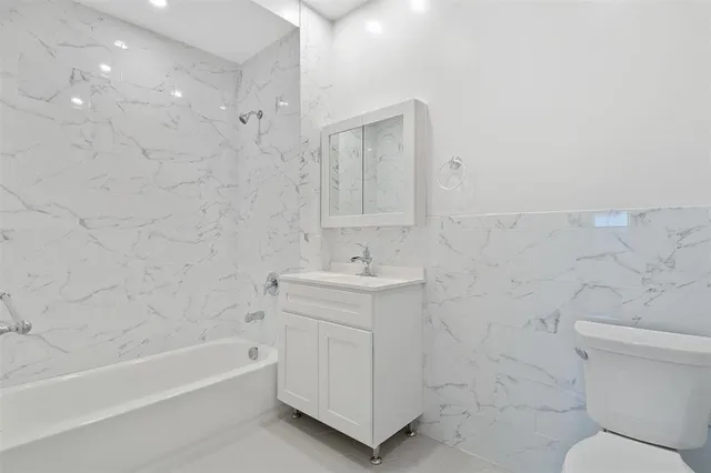 a bathroom with a sink a toilet and bathtub