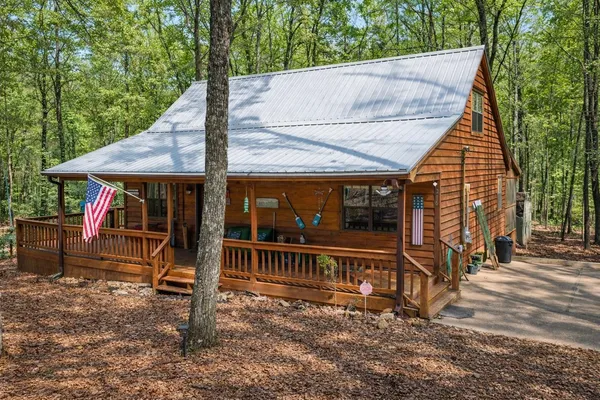 a view of a house with backyard porch and sitting area