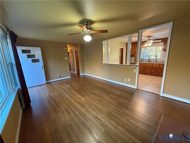 wooden floor in an empty room with a window