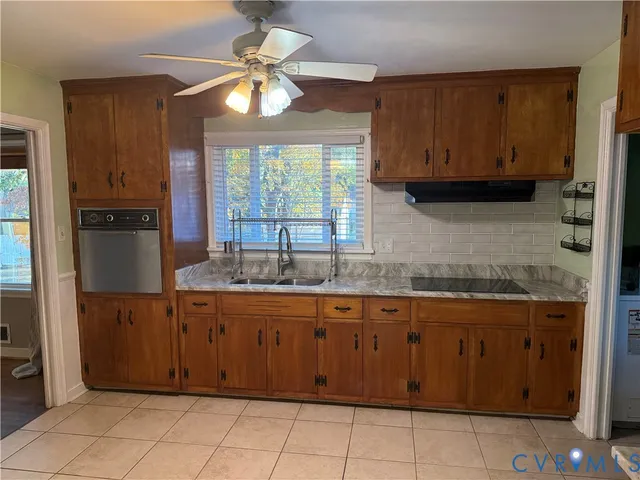 a kitchen with a sink cabinets and window