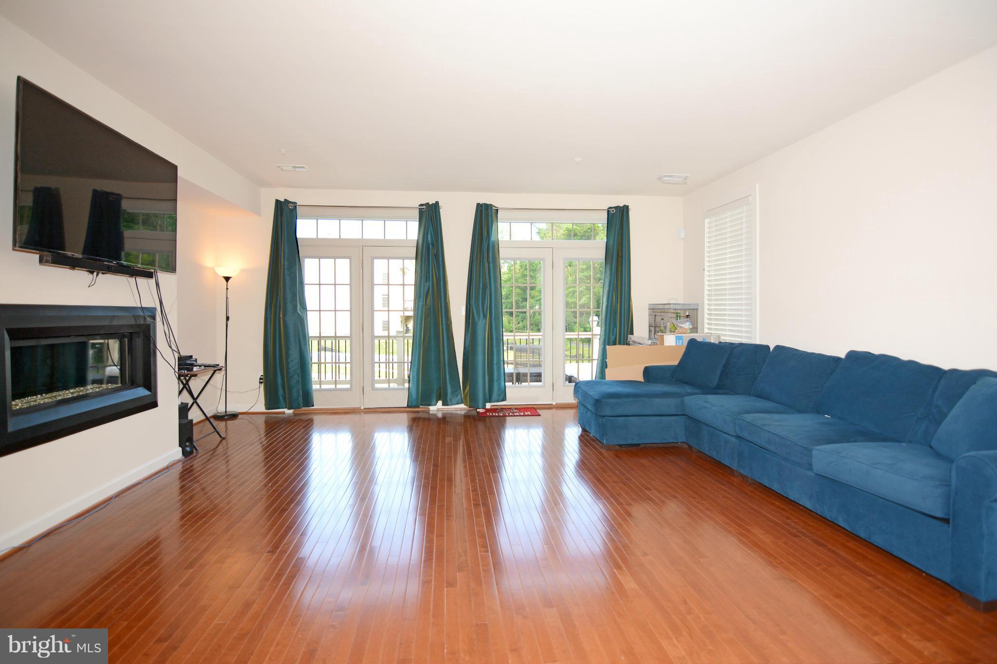 7403 Matapan Drive Hanover, MD 21076 - Photo 10 of 37 Living room opens to deck