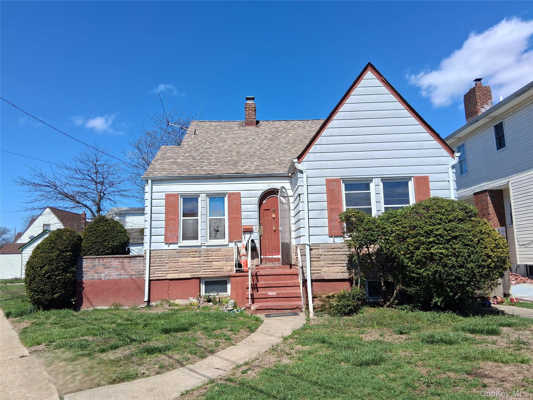 2 Fordham Place Hempstead, NY 11550 - Photo 2 of 7 a front view of a house with a yard