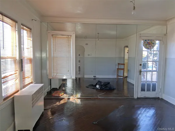 a living room with furniture window and wooden floor