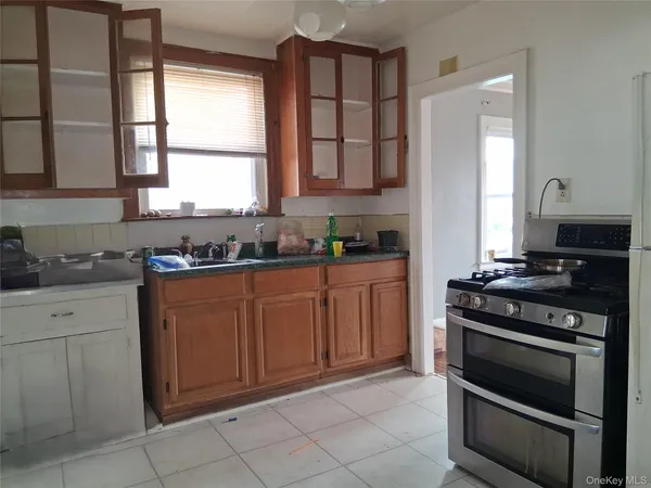 a kitchen with granite countertop a stove and a sink
