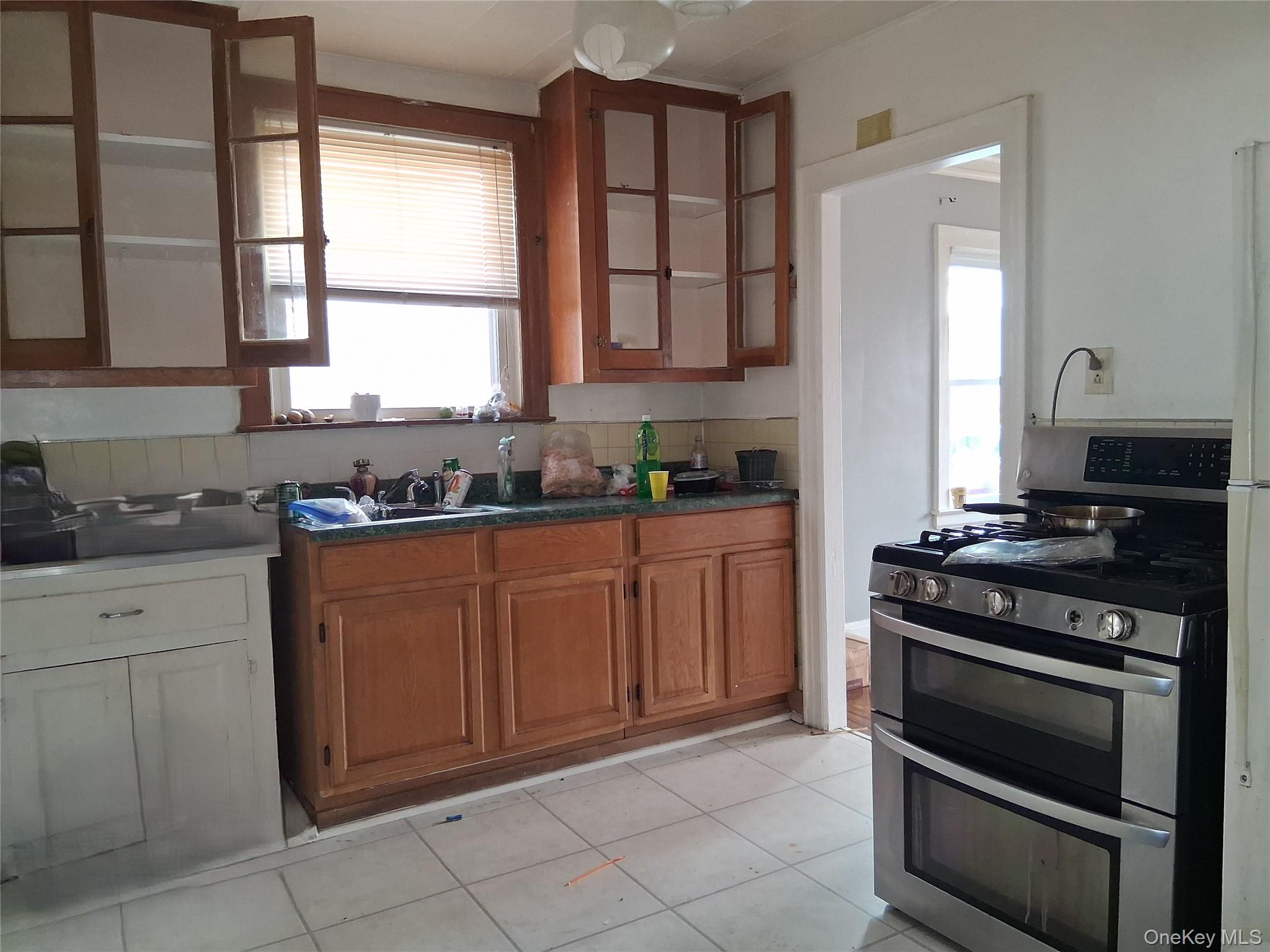 2 Fordham Place Hempstead, NY 11550 - Photo 4 of 7 a kitchen with granite countertop a stove and a sink