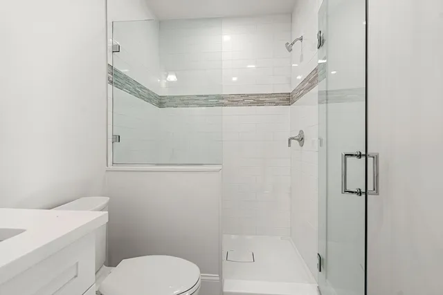 a bathroom with a toilet a sink and shower