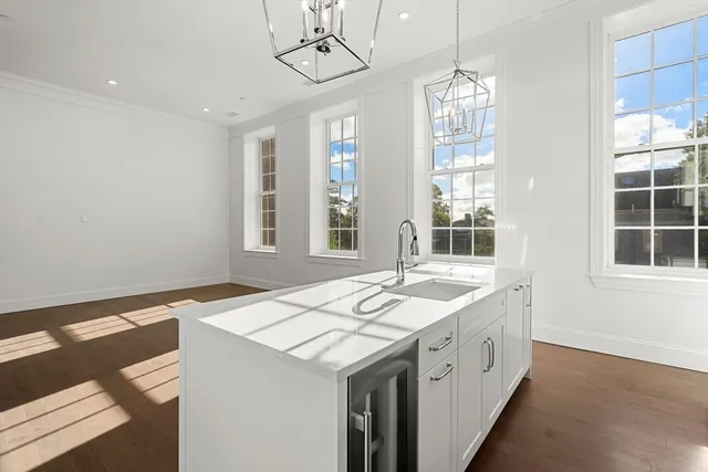 a spacious bathroom with a granite countertop sink and a window