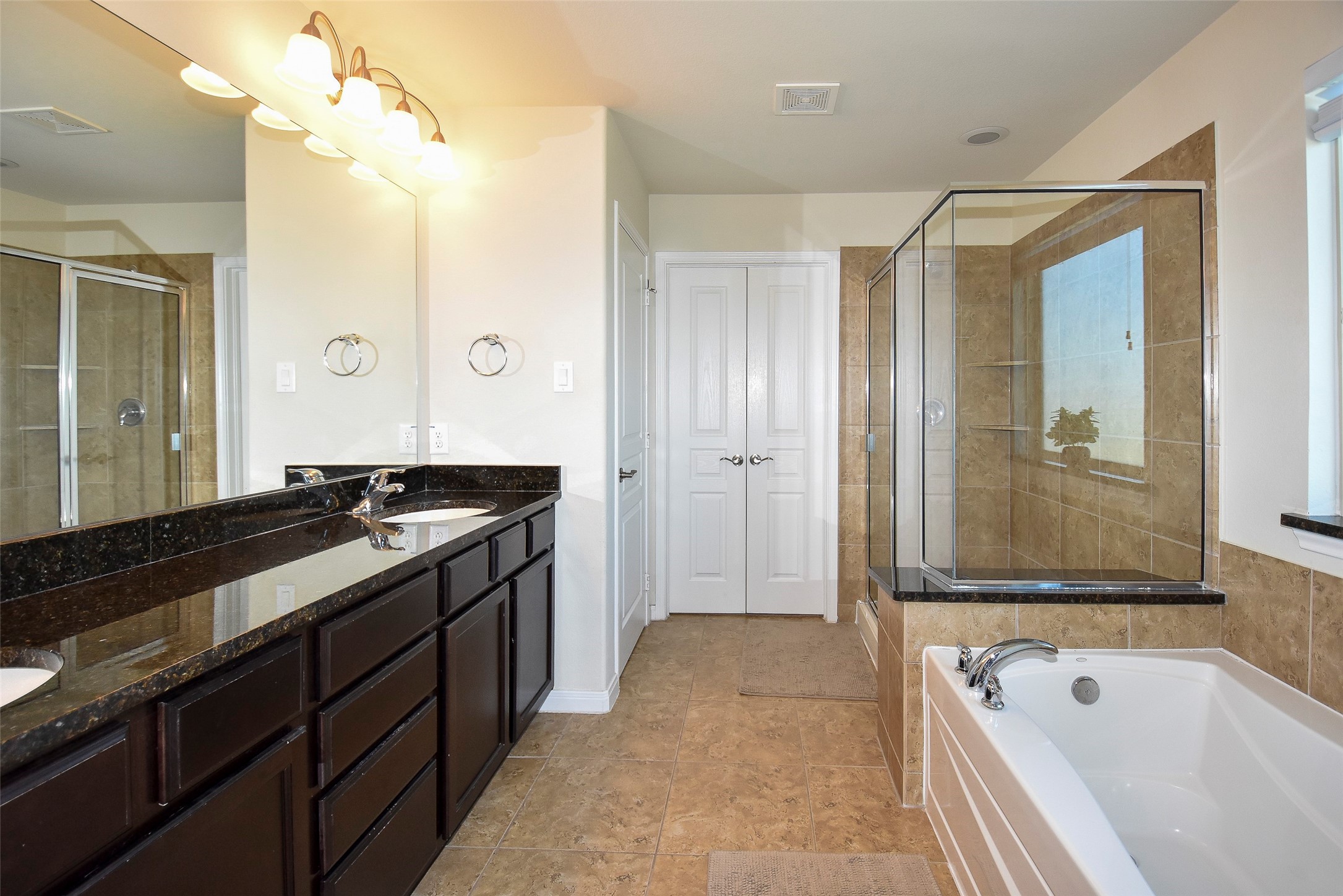 6427 Addlestone Ridge Lane Katy, TX 77494 - Photo 21 of 32 Primary bathroom with granite countertops, double sinks, tub, separated shower and walk-in closet.