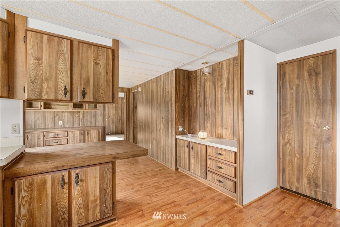 253 Stowell Road Salkum, WA 98582 - Photo 11 of 31 a kitchen with white cabinets and wooden floor