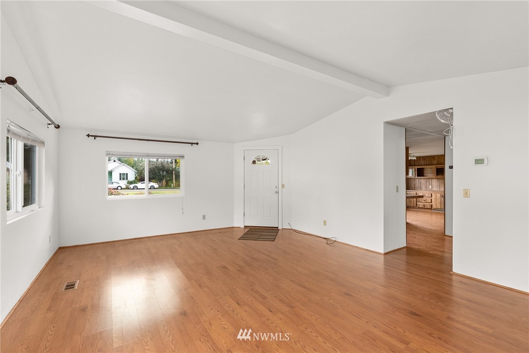 253 Stowell Road Salkum, WA 98582 - Photo 8 of 31 an empty room with wooden floor and windows