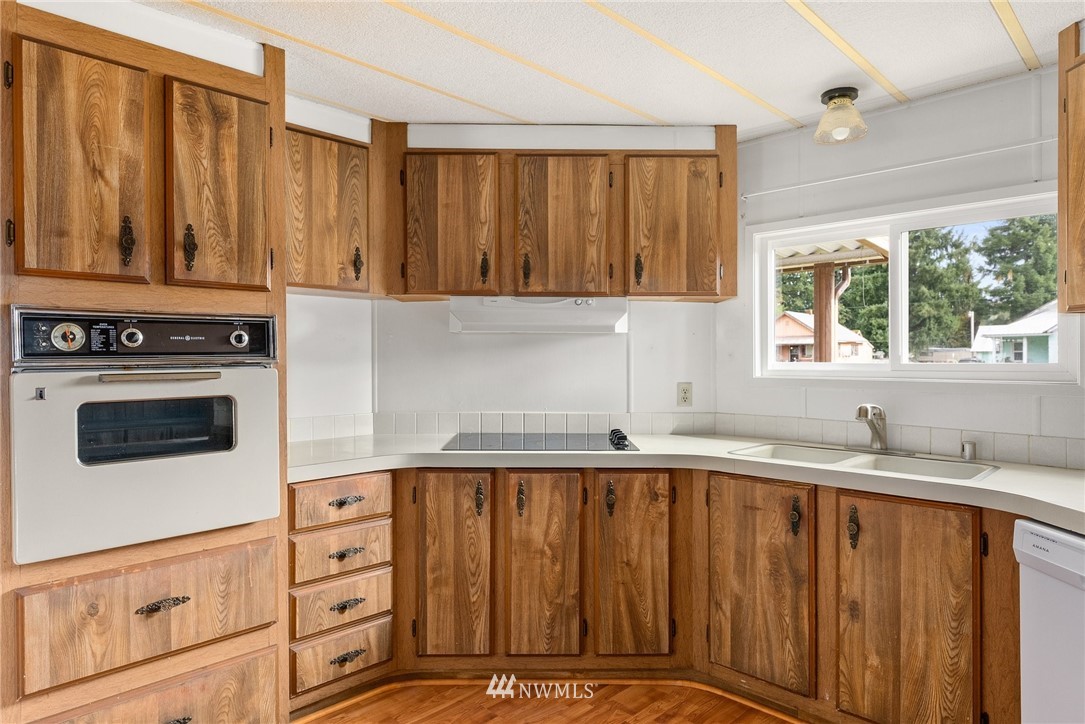 253 Stowell Road Salkum, WA 98582 - Photo 10 of 31 a kitchen with granite countertop a sink a stove and cabinets