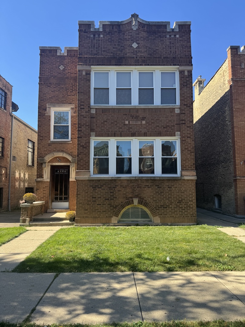 6208 North Artesian Avenue, Unit 2 Chicago, IL 60659 - Photo 1 of 14 a front view of a house with a yard