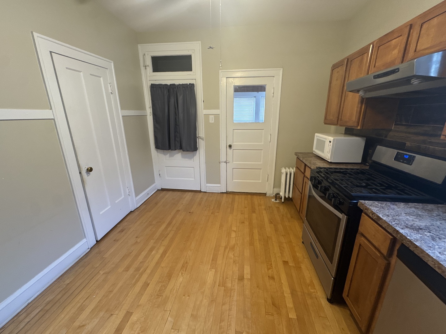 6208 North Artesian Avenue, Unit 2 Chicago, IL 60659 - Photo 12 of 14 a kitchen with a sink and wooden floor