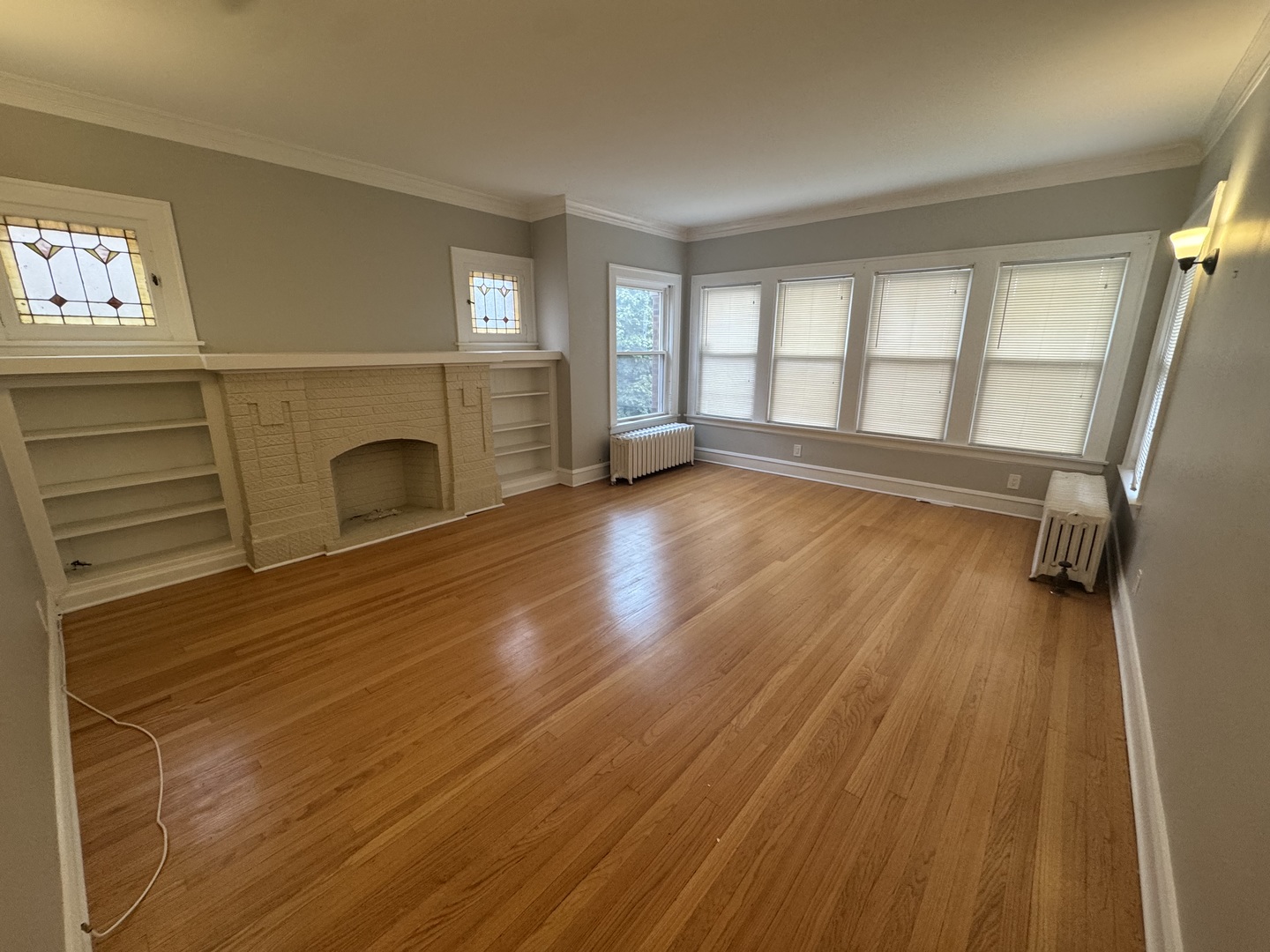 6208 North Artesian Avenue, Unit 2 Chicago, IL 60659 - Photo 2 of 14 a view of a livingroom with wooden floor and a fireplace