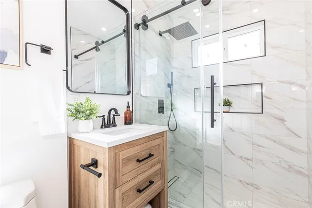 a bathroom with a sink vanity granite and a mirror