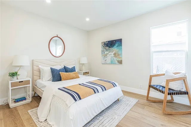 a bedroom with bed and a chair