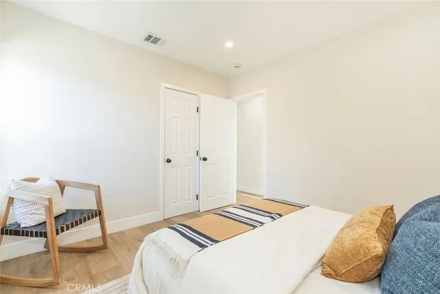 a bedroom with a bed and a chair