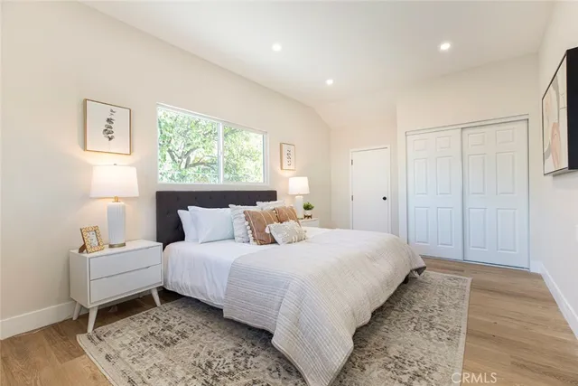 a bedroom with bed and a window