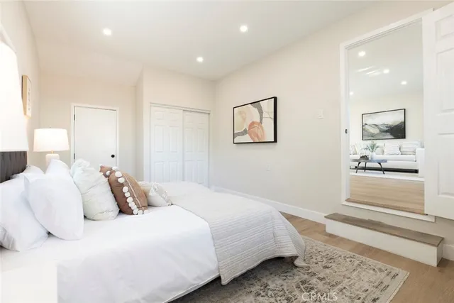 a bedroom with a bed and a painting on the wall