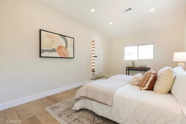 a bedroom with a bed and a painting on the wall