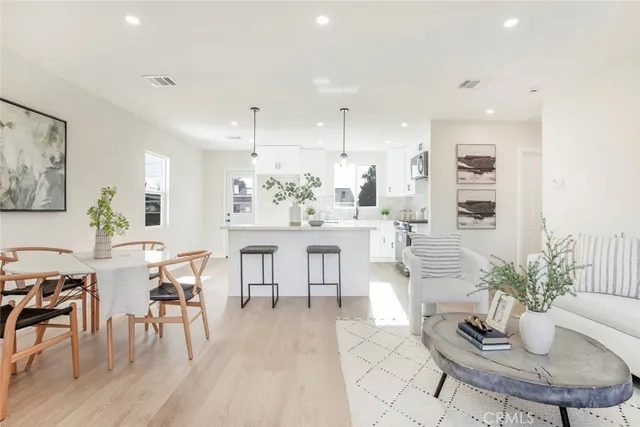 a living room with furniture and a dining table