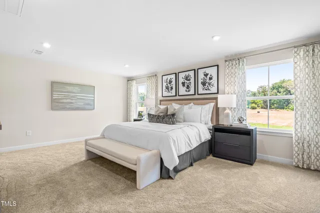 a spacious bedroom with a large bed and a window