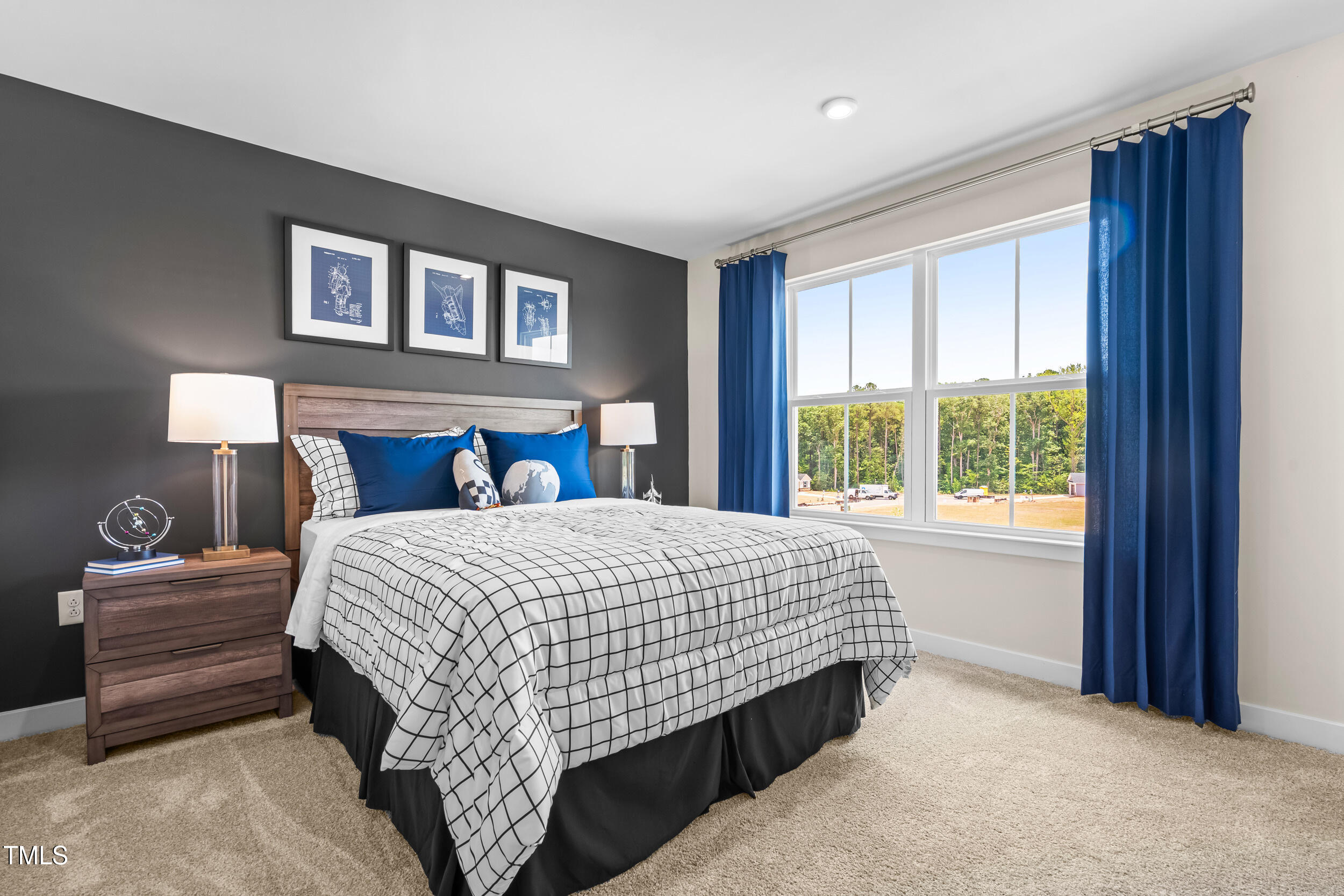 809 Walker Rdg Way Willow Spring, NC 27592 - Photo 23 of 33 a bed sitting in a bedroom next to a window