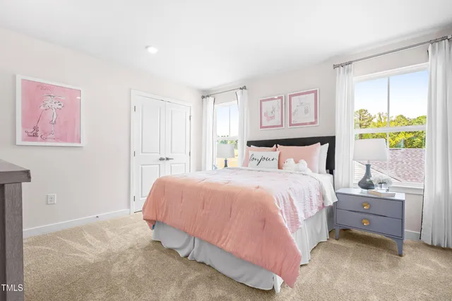 a bed sitting in a bedroom next to a window