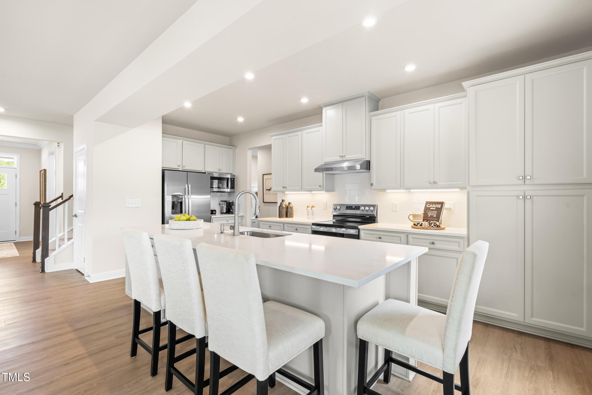 809 Walker Rdg Way Willow Spring, NC 27592 - Photo 5 of 33 a kitchen with stainless steel appliances a refrigerator a stove a sink a dining table and chairs