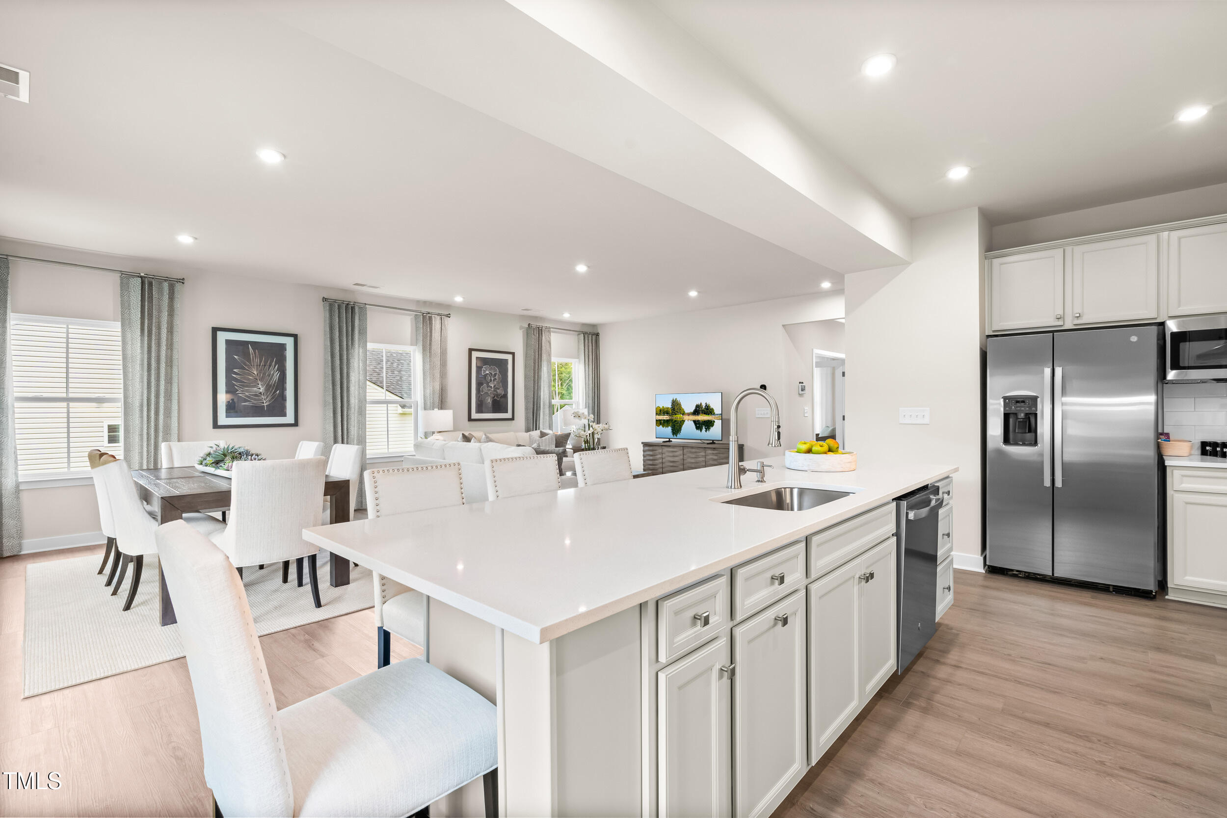 809 Walker Rdg Way Willow Spring, NC 27592 - Photo 6 of 33 a large kitchen with kitchen island a large counter top space a sink stainless steel appliances and cabinets