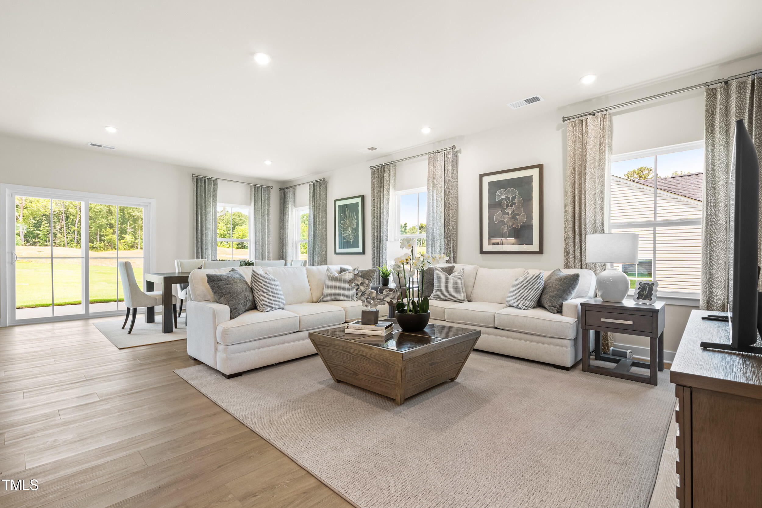 809 Walker Rdg Way Willow Spring, NC 27592 - Photo 8 of 33 a living room with furniture and a large window