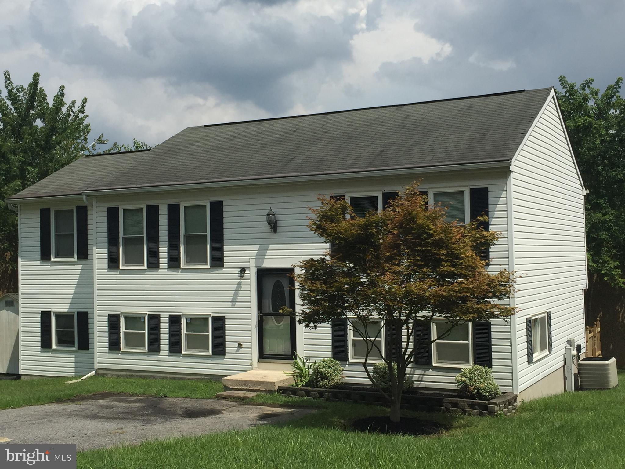 1329 Willow Spring Road Baltimore, MD 21228 - Photo 2 of 24 a front view of a house with a yard