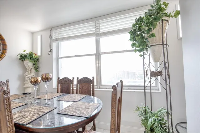 a dining room with furniture window and wooden floor