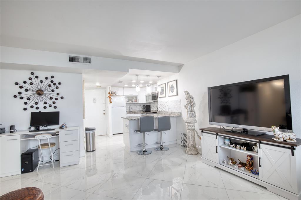 111 Briny Avenue, Unit 2008 Pompano Beach, FL 33062 - Photo 12 of 50 a living room with furniture and a flat screen tv