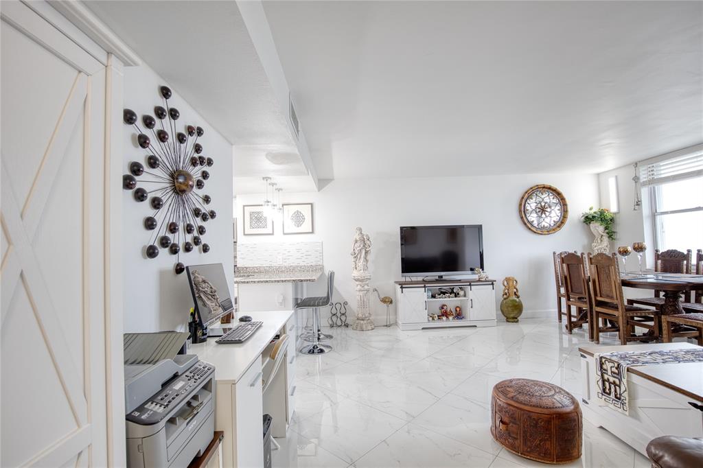 111 Briny Avenue, Unit 2008 Pompano Beach, FL 33062 - Photo 17 of 50 a living room with furniture and a flat screen tv
