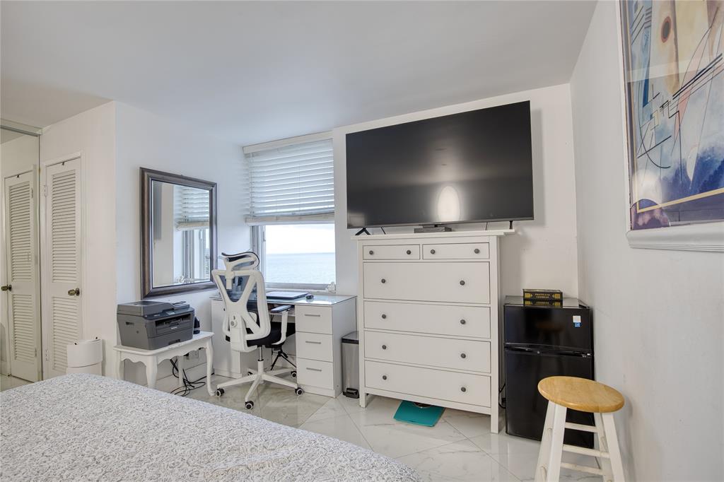 111 Briny Avenue, Unit 2008 Pompano Beach, FL 33062 - Photo 21 of 50 a living room with furniture and a flat screen tv
