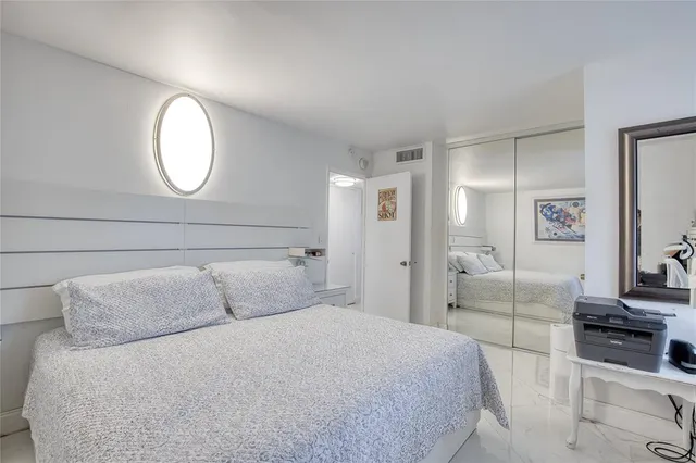 a bedroom with a bed and a mirror