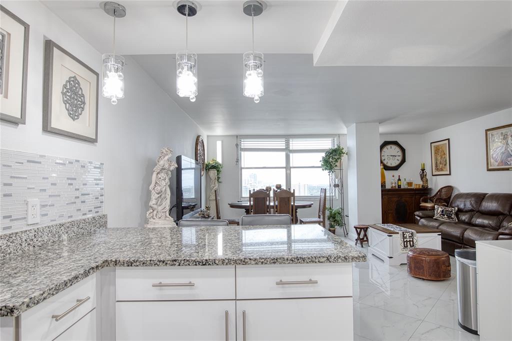 111 Briny Avenue, Unit 2008 Pompano Beach, FL 33062 - Photo 3 of 50 a kitchen with granite countertop cabinets a stove a sink and a granite counter top