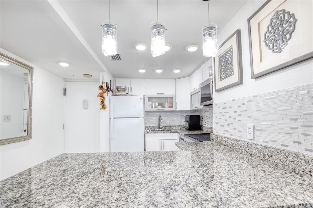 111 Briny Avenue, Unit 2008 Pompano Beach, FL 33062 - Photo 5 of 50 a view of a kitchen with a sink and a refrigerator