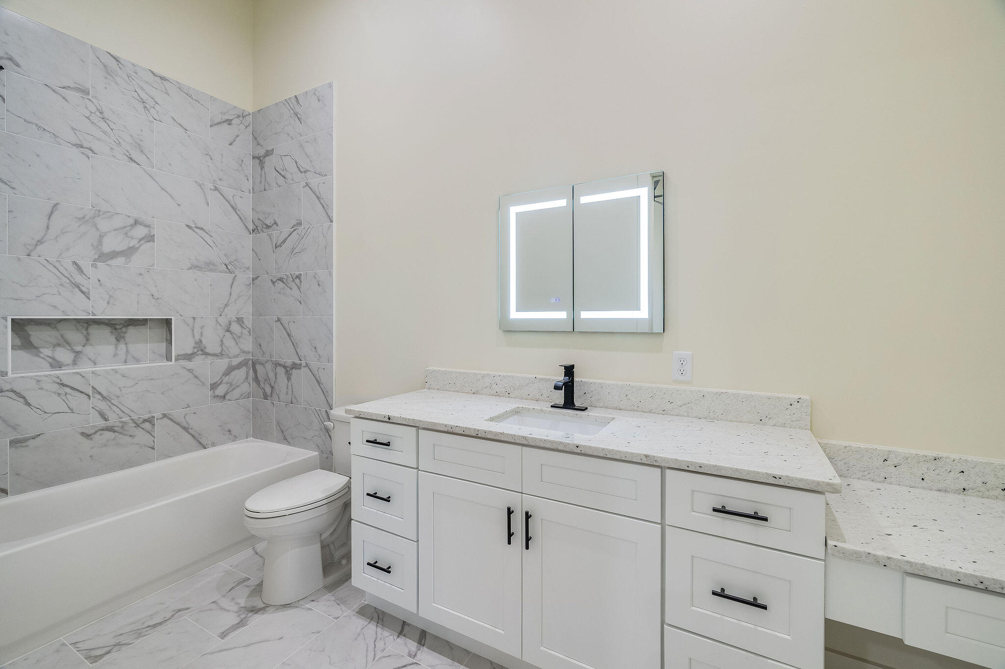 32 Delbert Lane, Unit B Santa Rosa Beach, FL 32459 - Photo 6 of 13 a bathroom with a granite countertop sink a toilet and a bathtub