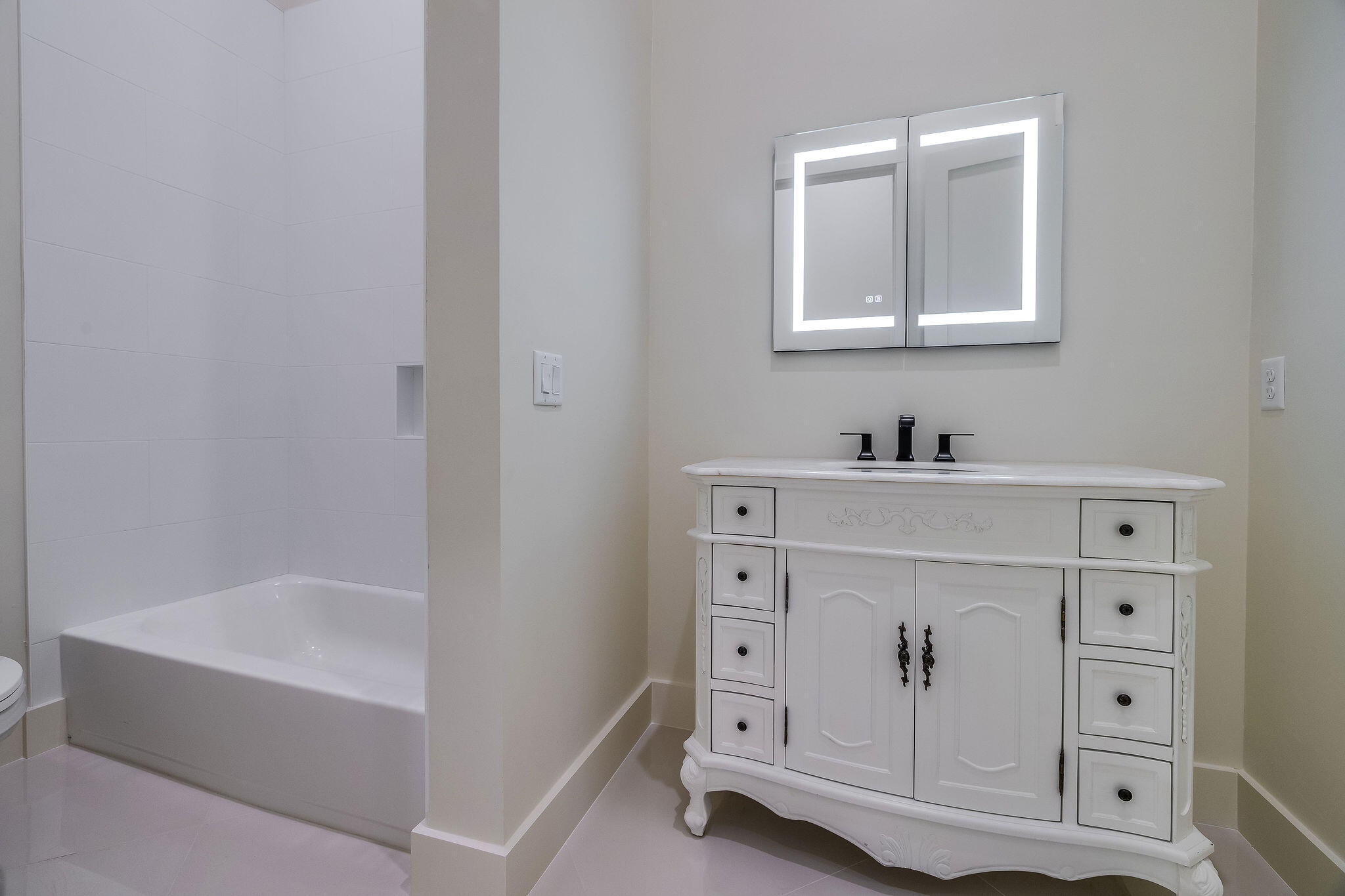 32 Delbert Lane, Unit B Santa Rosa Beach, FL 32459 - Photo 10 of 13 a bathroom with a bathtub sink and mirror
