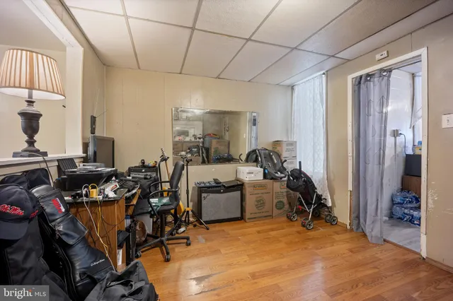 a kitchen with a table chairs refrigerator and cabinets