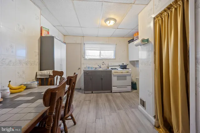 a bedroom with a bed and a refrigerator