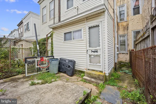 a view of a blue house with a yard