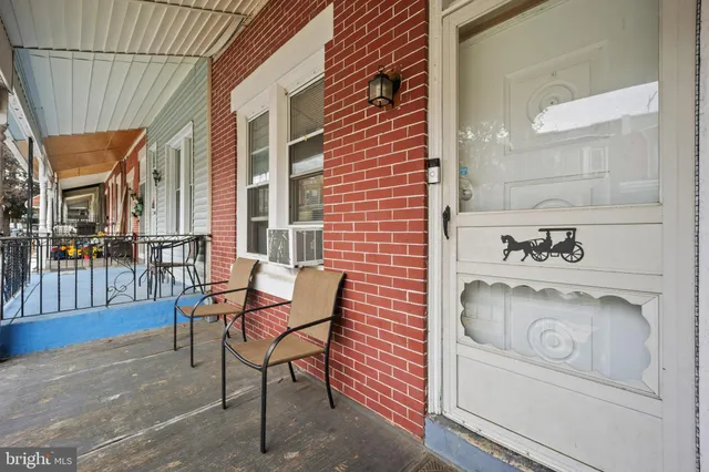 a building outdoor space with patio furniture and potted plants