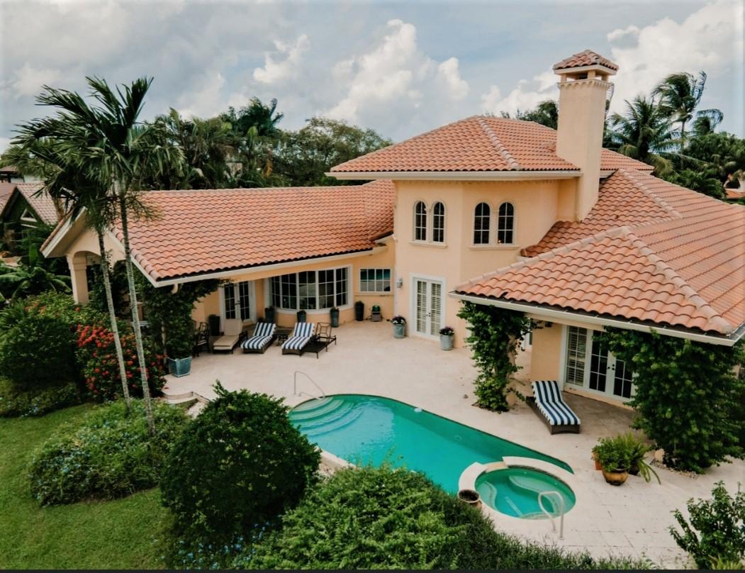 an aerial view of a house with swimming pool and patio