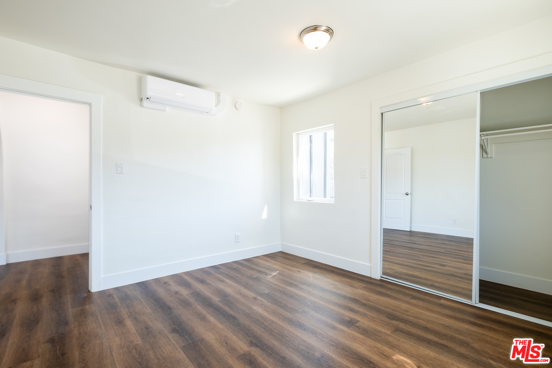 626 Silver Boulevard Los Angeles, CA 90026 - Photo 12 of 24 a view of an empty room with wooden floor and a window